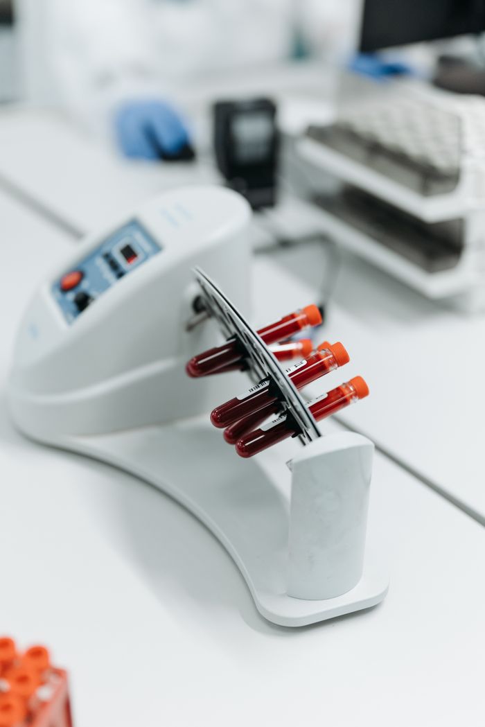 Home Close-up of a laboratory centrifuge holding blood samples in test tubes.
